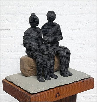 Boaz Vaadia Family 1 (#146) BVE (2017), a bronze and bluestone figurative sculpture featuring two seated figures resting on a boulder, measuring 20 x 21 x 15 inches. This stacked stone artwork merges ancient techniques with modern abstraction, available a
