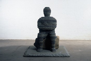 Boaz Vaadia STONE - Ba'al (1996), bluestone and boulder sculpture, 49 x 46.5 x 46.5 inches. A layered human figure seated on a natural boulder, reflecting earthy materiality, ancient sculptural influences, and meditative presence.