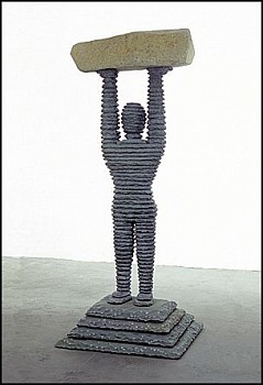 Boaz Vaadia Shimshon (#48) (1998), bronze, bluestone, and boulder sculpture, 80 x 34 x 29 inches. A layered, human-like figure lifting a heavy stone, representing strength, endurance, and the harmony between nature and human resilience.